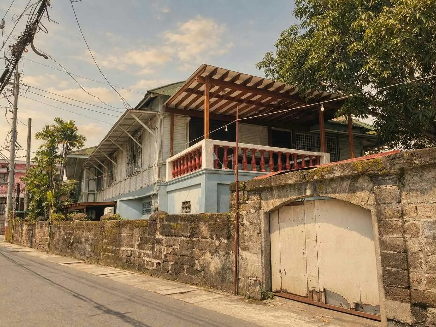 Historic ancestral house behind a stone wall along Kamestisuhan District, Malolos