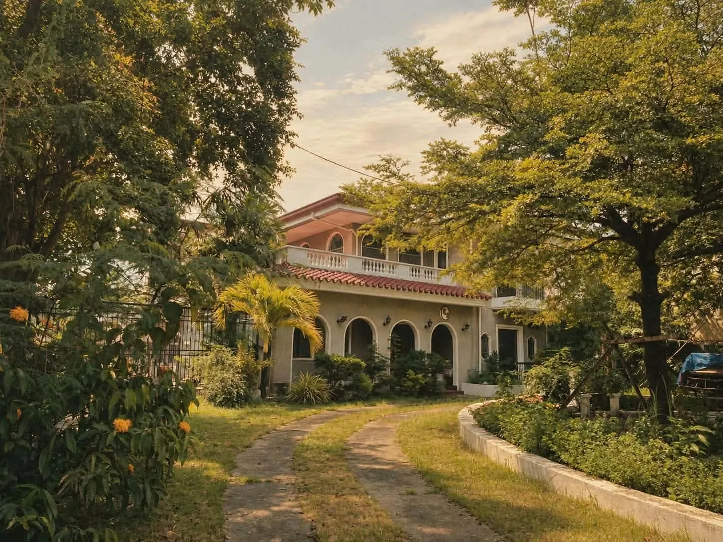 Heritage building among trees and a garden in Malolos