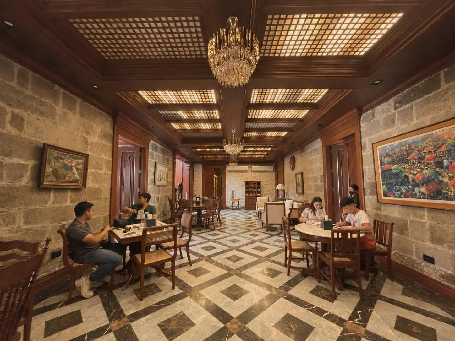 Diners in a heritage-style room with patterned tile floor and wooden ceiling