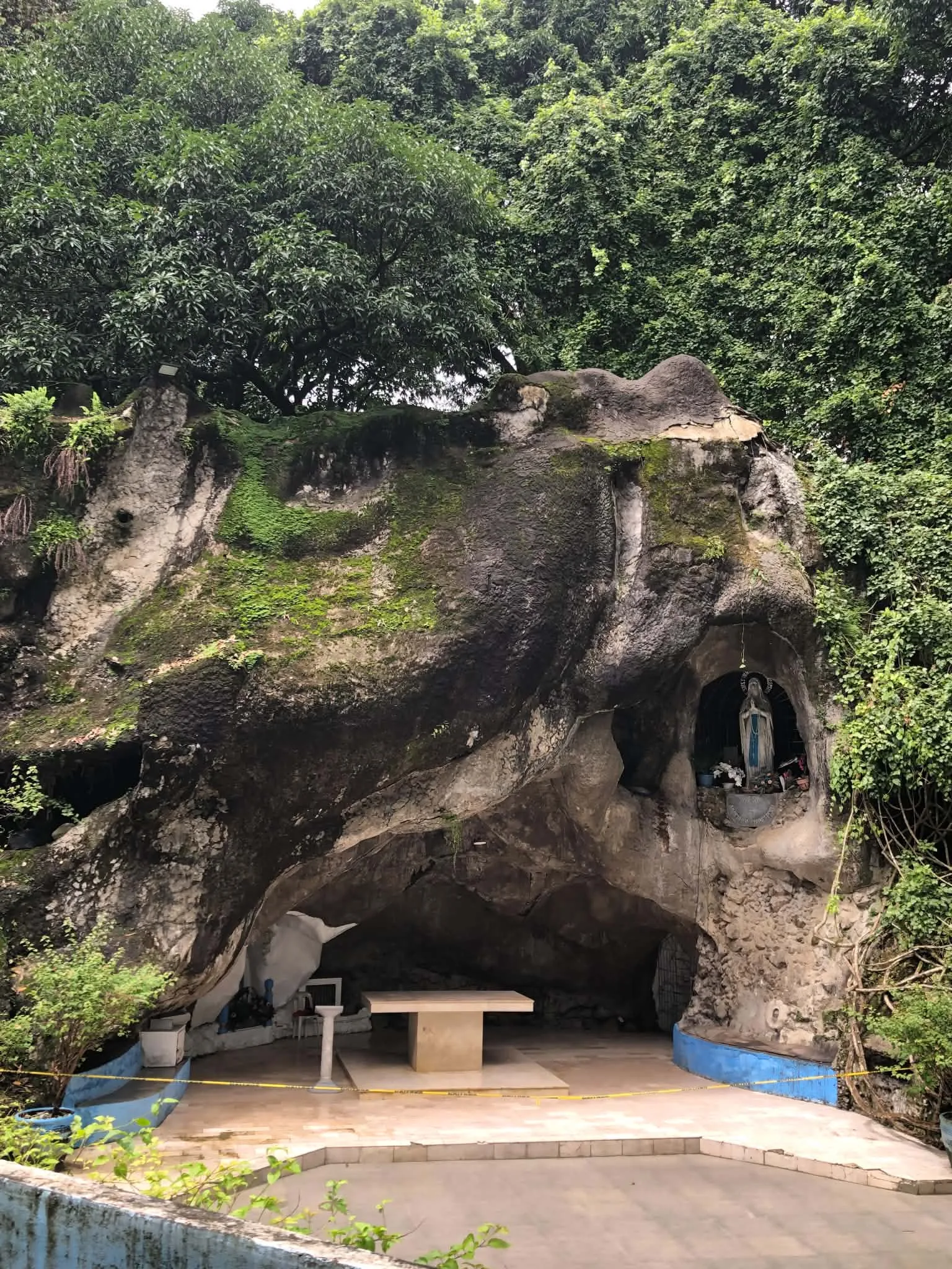 Rock grotto and prayer space surrounded by trees