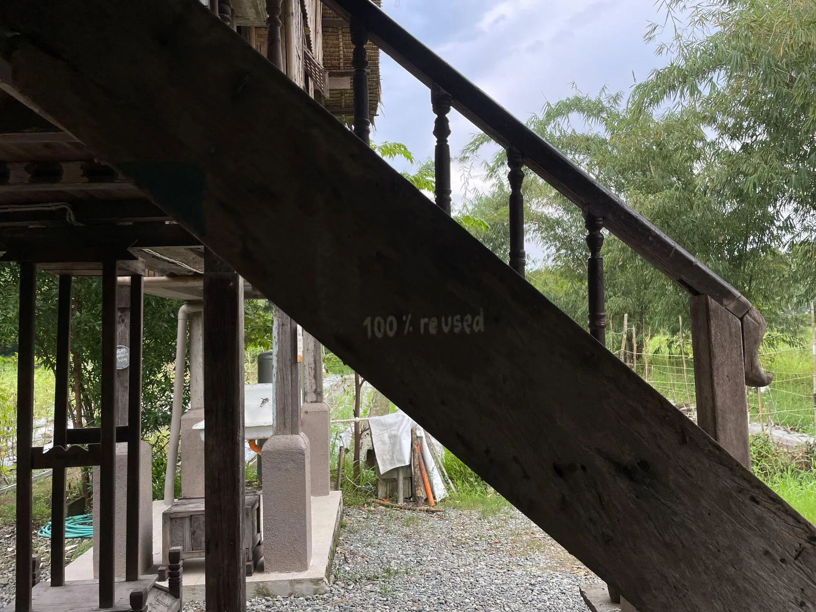 Reused wooden timber supporting a rustic structure at Pulong Kabyawan