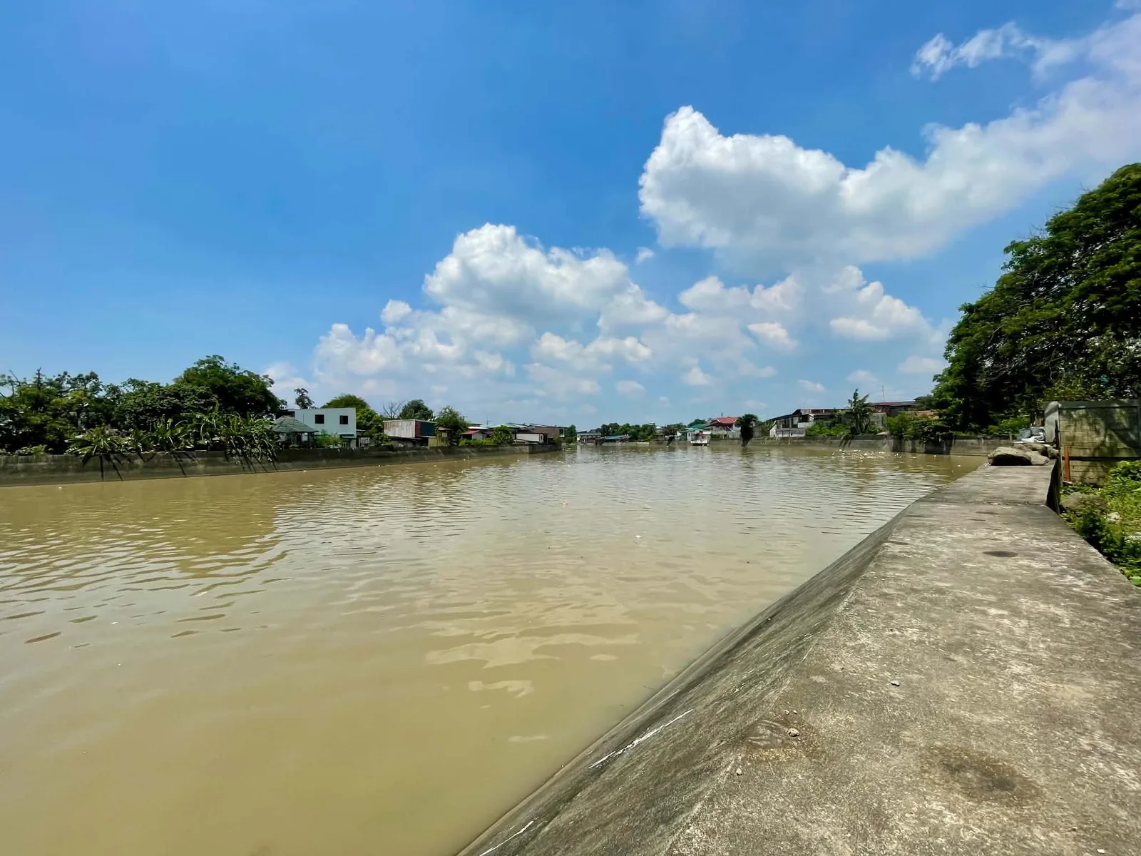 Riverbank path overlooking the Wawa River in Bocaue