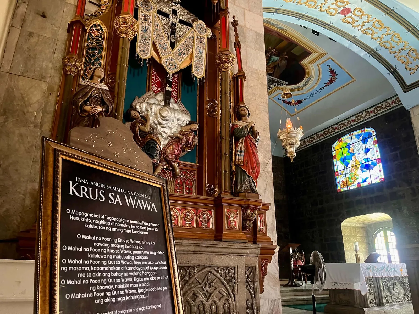 Holy Cross of Wawa devotional display photographed inside a church in Bocaue