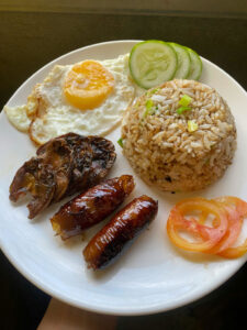Filipino family sharing breakfast at a homestay for cultural immersion Philippines