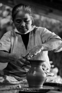Potter shaping clay during a workshop representing cultural immersion Philippines