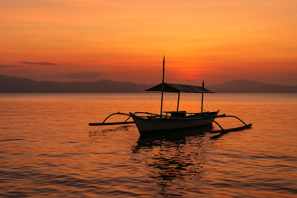 Sorsogon Travel Guide: Whale Sharks, Hot Springs, and Laid-Back Shores Donsol Bay sunset scene with banca for Sorsogon travel guide