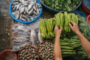 Overhead market stall in Iloilo filled with fish and greens showing Iloilo fresh flavors