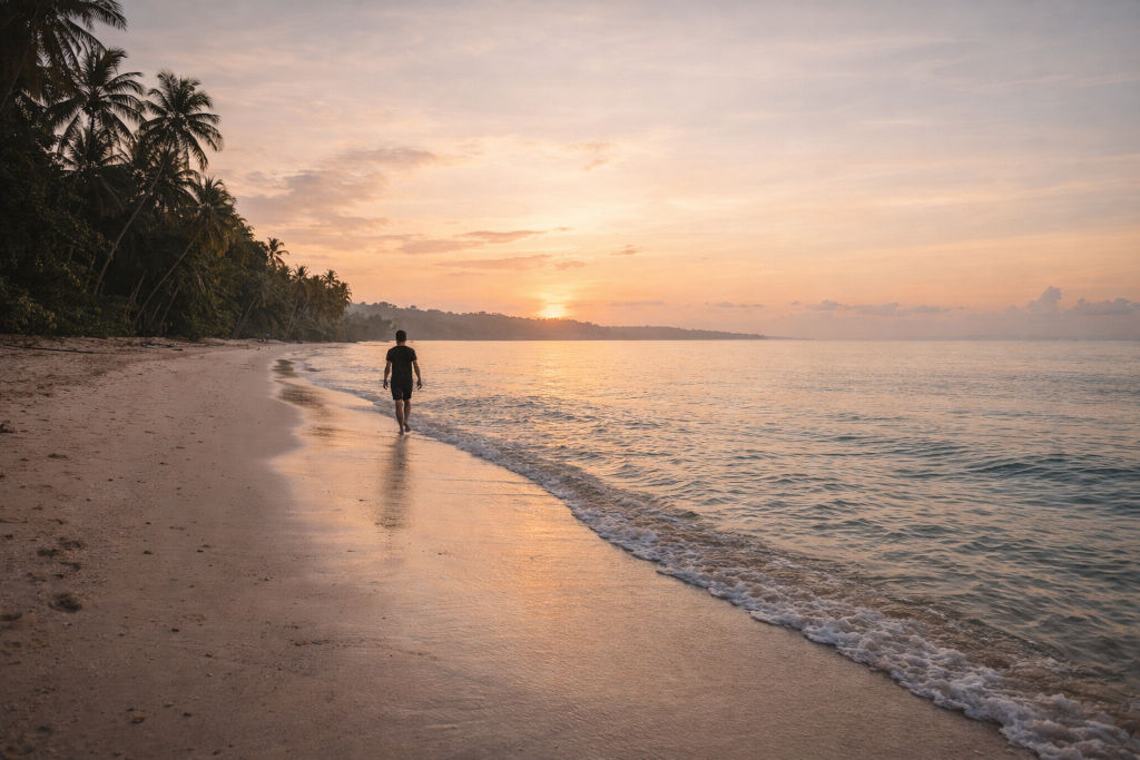 Quiet sunrise shoreline walk during a nature travel reset