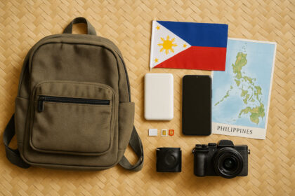 Flat lay of travel tech Philippines essentials with backpack and gadgets