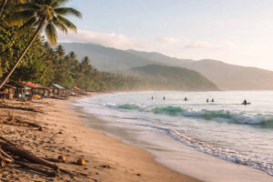Baler Travel Guide view of Sabang Beach in Baler, Aurora in the morning with small waves and surfers