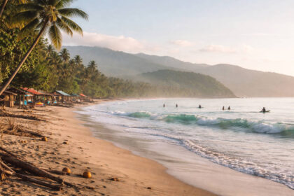 Baler Travel Guide: Where to Stay, What to Do, and Low-Stress Planning Baler Travel Guide view of Sabang Beach in Baler, Aurora in the morning with small waves and surfers