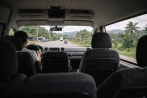 Bohol countryside travel guide image showing van seats and a provincial road through the window