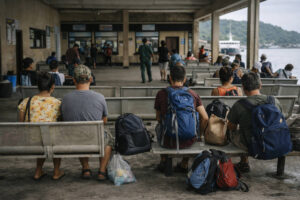 Port waiting area in Romblon with travelers and bags before a boat departure for how to get around Romblon