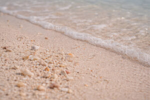 Wet sand close-up showing subtle pink tone at pink beach sorsogon