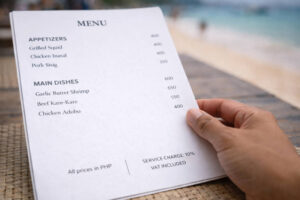 Best Restaurants In Boracay menu close-up showing service charge and VAT included notes