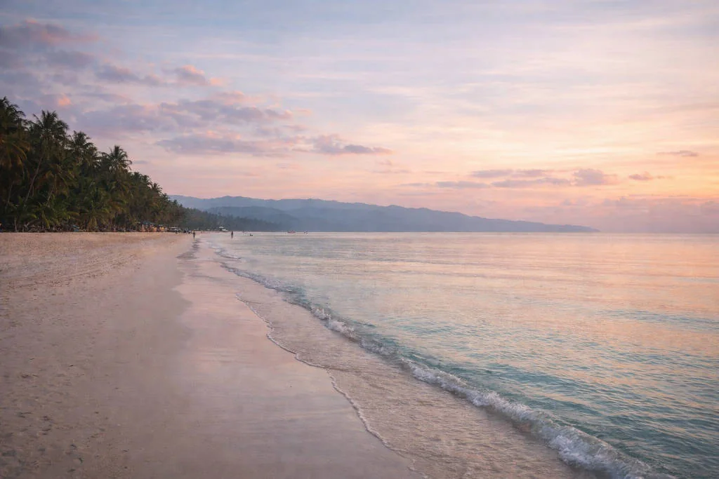 Early morning view of White Beach in Boracay for free things to do in Boracay with calm water and few people