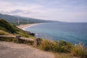 Scenic coastline for Ilocos Norte travel guide with windmills and open landscape