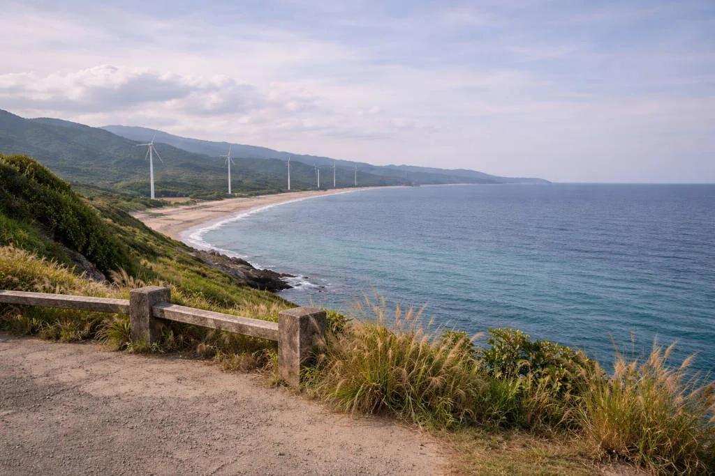 Scenic coastline for Ilocos Norte travel guide with windmills and open landscape