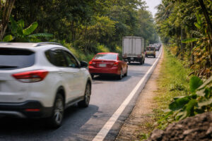 No expressway routes Luzon small motorcycle higher-risk road cue with no shoulder and fast traffic mix in Luzon