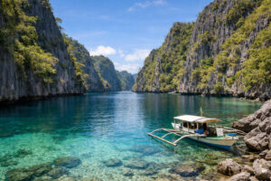 Wide view of Twin Lagoon with limestone cliffs and a boat in Coron