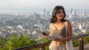Mika planning a calm first visit with Cebu City travel tips and the Cebu City skyline behind her