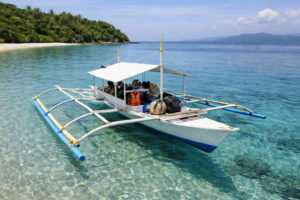 Small island-hopping boat on clear water near Romblon Island