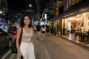 Solo travel Cebu City street at night with lights, visible people, and realistic safety conditions