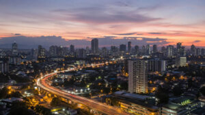 Solo travel Cebu City skyline at dusk with calm evening lights and visible roads