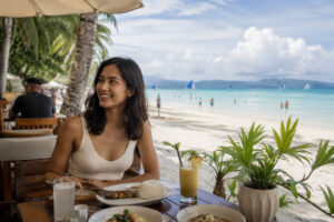 Boracay vs Siargao guide showing relaxed beachfront dining atmosphere in Boracay