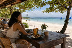 Boracay vs Siargao guide showing Mika relaxed beachfront dining atmosphere in Boracay