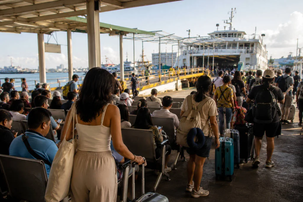 Passengers waiting with bags before a Cebu City to Siquijor ferry