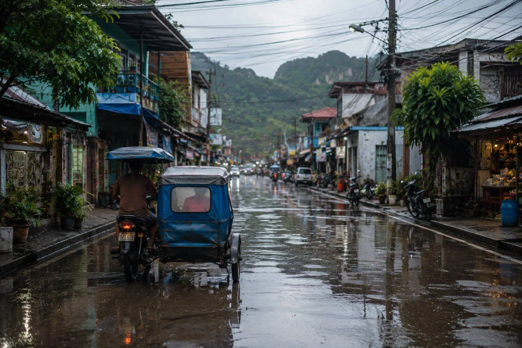 Tricycle transport during a coron rainy day in wet weather