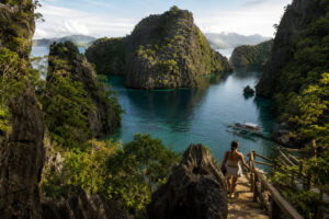 Coron with Kids visit to Kayangan Lake with calm water and limestone cliffs.