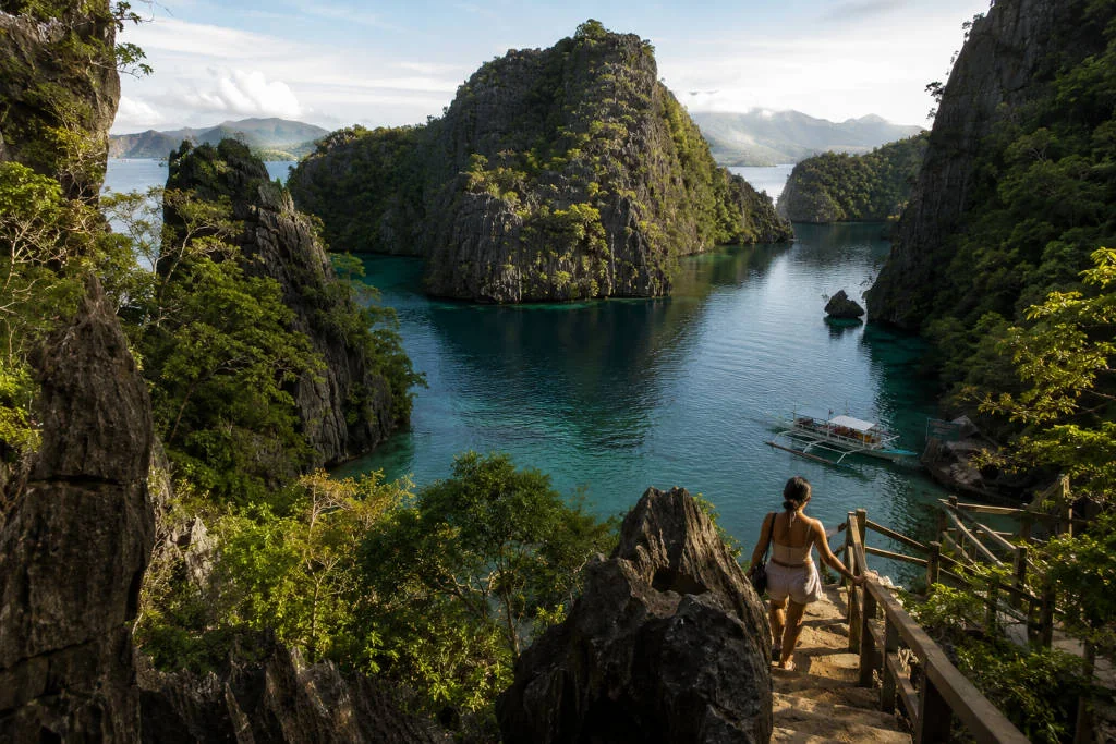 Coron with Kids visit to Kayangan Lake with calm water and limestone cliffs.