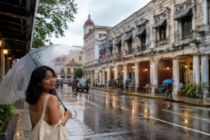Iloilo City rainy season travel mood with umbrellas and wet heritage streets