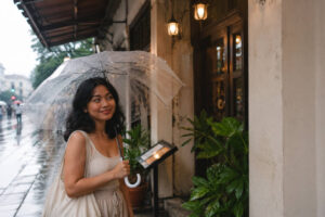 Mika with an umbrella during Iloilo City rainy season travel