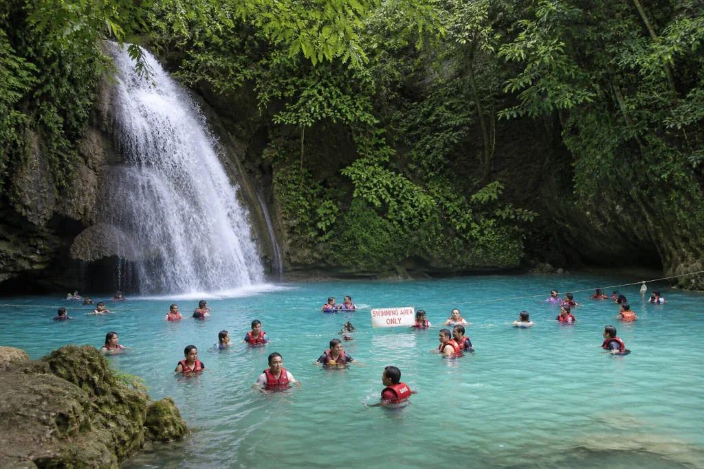 Visitors wearing life vests at the swimming area of Kawasan Falls Cebu