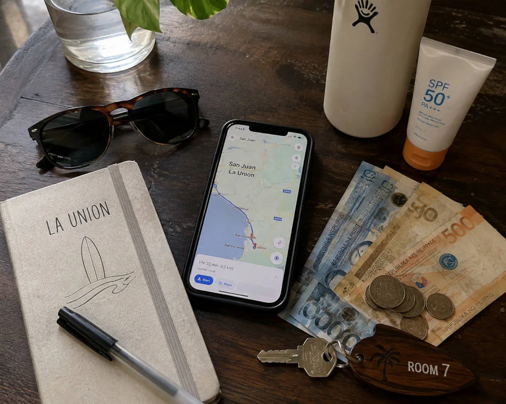 La Union travel tips shown through a first-day planning checklist with cash and map