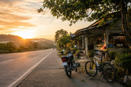 Small motorcycle and bicycle prepared for the Manila to Baler motorcycle route at sunrise
