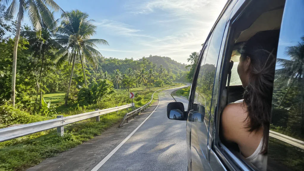 Private vehicle on a quiet road showing how to get around Bohol countryside comfortably
