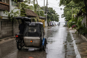Wet road and tricycle transport on a Moalboal rainy day