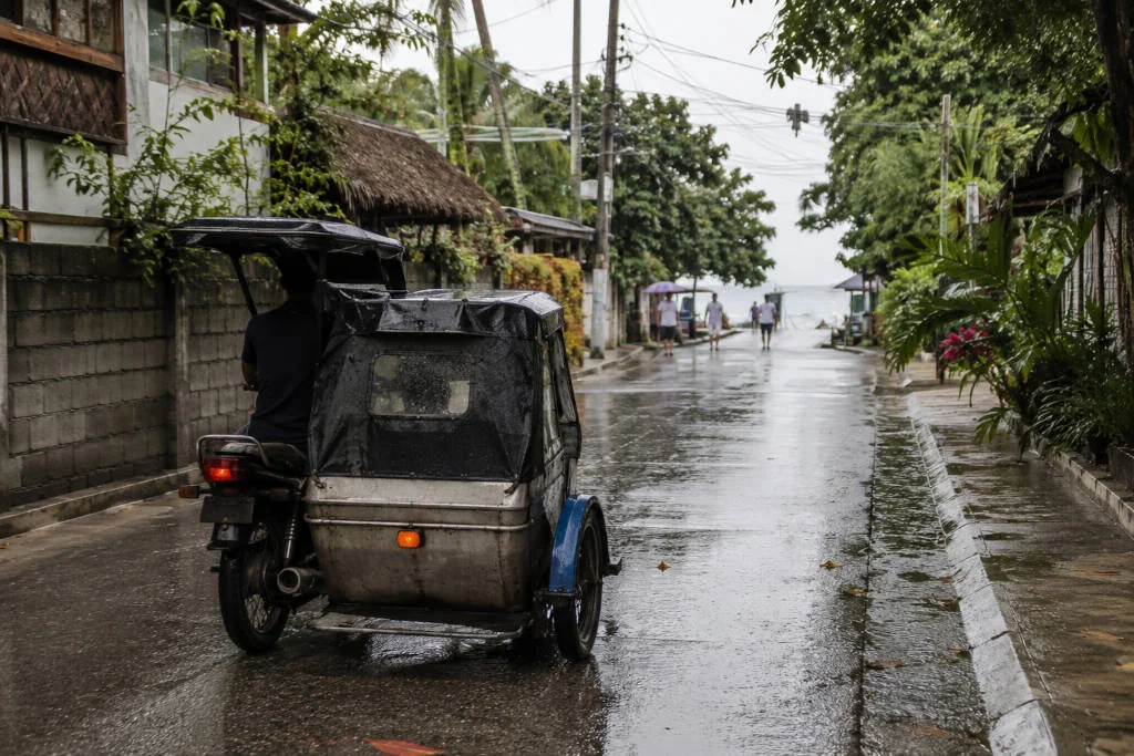 Wet road and tricycle transport on a Moalboal rainy day