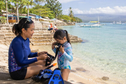 Moalboal With Kids: Easy Activities and Parent-Friendly Tips Parent and child preparing for an easy Moalboal with kids snorkeling day