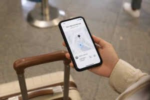 Phone showing ride pickup details for a NAIA to BGC transfer